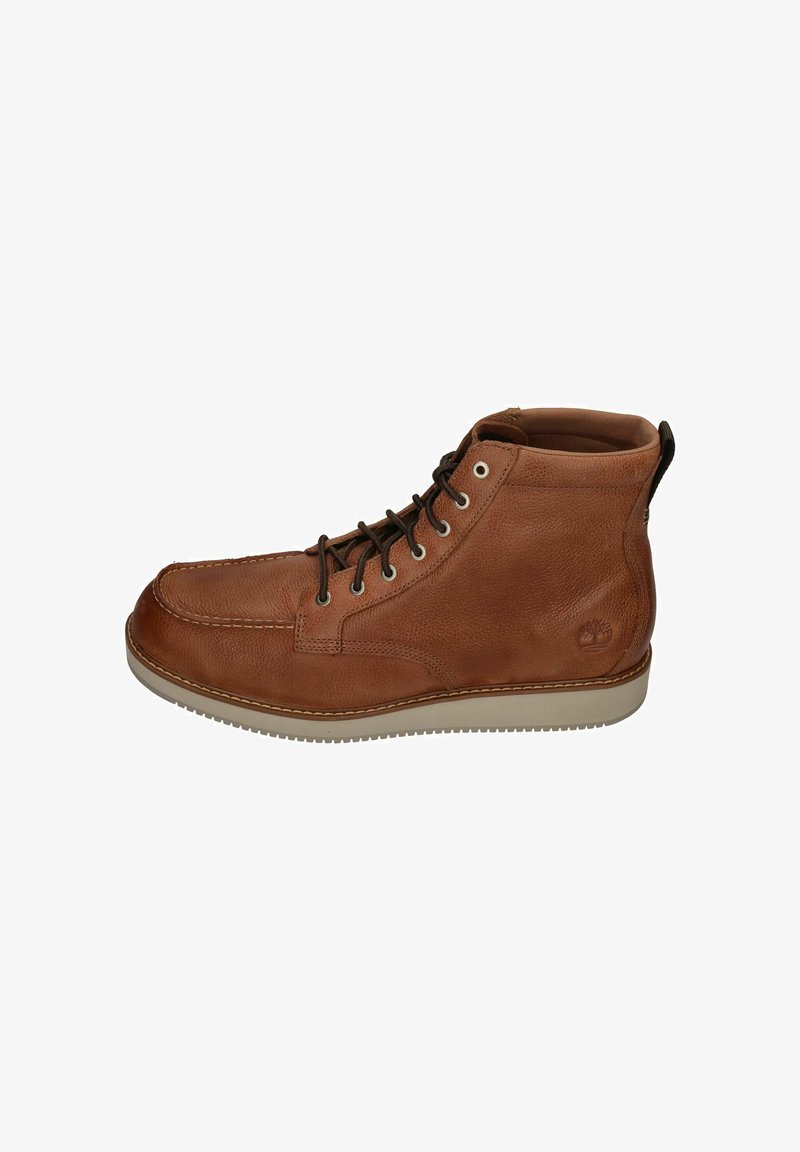 Brown leather boot with a textured finish, rounded toe, and lace-up design. Features light-colored rubber sole and logo on the heel.