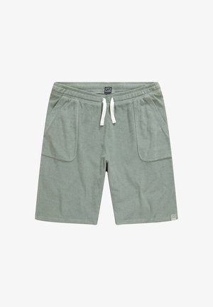 Pantalones cortos de sudadera de algodón en verde claro, con dos grandes bolsillos frontales, una cinturilla elástica con cordón blanco y una textura suave.
