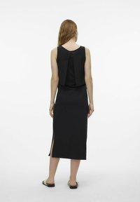 Black sleeveless dress featuring a split design at the back, side slits, and a smooth, form-fitting silhouette.