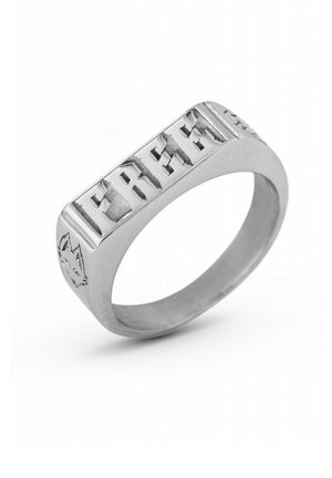 Silver ring featuring a rectangular band with engraved letters spelling "FREE" and a small animal motif on the side. Smooth, polished texture.