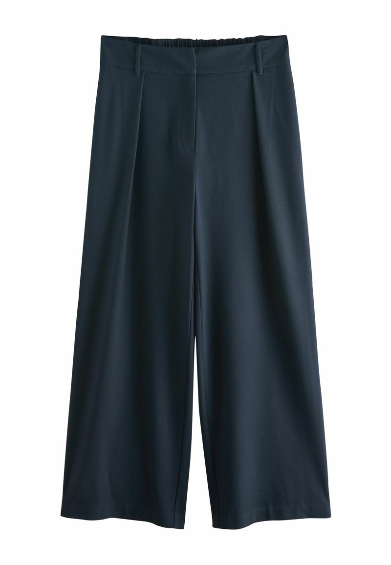 Pantalons larges bleu marine avec passants de ceinture, devant plat et taille élastiquée à l'arrière, présentés sur un fond blanc.