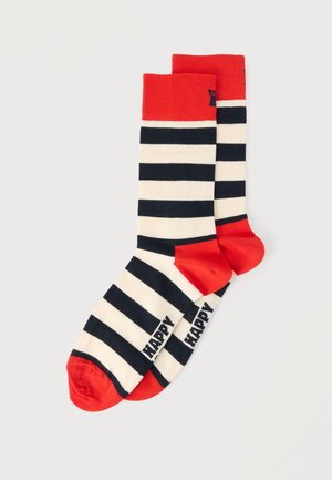 Pair of crew socks with black and white horizontal stripes, red cuffs, heels, toes, and "HAPPY" text near the toes on each sock.