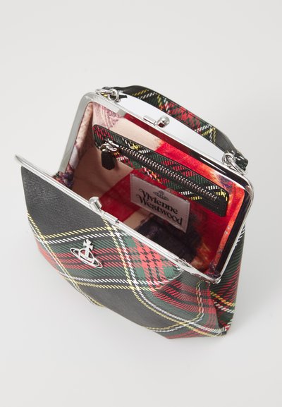 Tartan-patterned handbag in black, red, and green with silver hardware. Interior features a contrasting fabric and a zippered pocket.