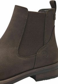 Bottine en cuir marron avec des panneaux latéraux élastiques, finition texturée et semelle légèrement crantée. Présente un détail de logo près du talon.