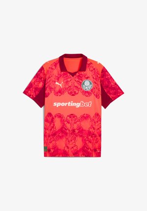 Maillot de soccer à manches courtes rose et rouge avec un motif floral, un col noir, et un logo circulaire avec "PALMEIRAS" sur la poitrine gauche.