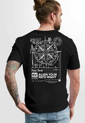 Black cotton t-shirt featuring a white compass design, graphic text, and intricate line work on the back, with a relaxed fit and short sleeves.