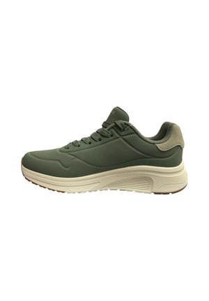 Sneaker sportiva verde con allacciatura frontale, collarino imbottito e suola beige spessa con battistrada testurizzato per la presa.