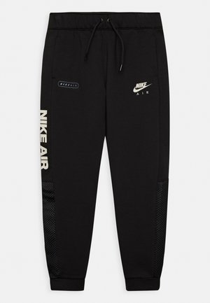 Czarne spodnie dresowe z regulowanym ściągaczem w talii, logo Nike, boczne kieszenie, wstawki z siateczki oraz napis "NIKE AIR" w kontrastujących beżowych odcieniach.