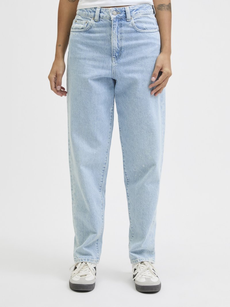 Person wearing light blue high-waisted straight-leg jeans with front pockets and white sneakers on a plain background.