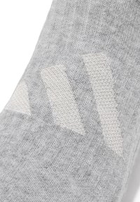 Gray knit sock featuring a textured pattern with three diagonal white chevron shapes on the side. Soft, elastic material for comfort.