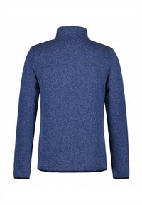 Giacca in pile di colore blu navy con colletto alto, maniche lunghe e tessuto testurizzato. Presenta un design pulito e minimalista senza abbellimenti.