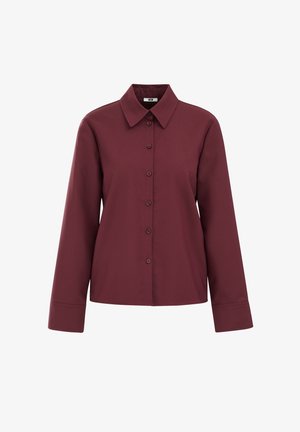 Bordo košulja dugih rukava s dušom ovratnikom, izrađena od glatkog materijala, ravnog donjeg ruba i s šest gumba sprijeda za zatvaranje.
