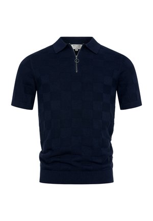 Polo en maille bleu marine à manches courtes avec motif à carreaux et fermeture éclair frontale avec un anneau circulaire.