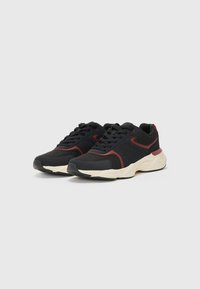 Black athletic sneakers with red accents, fabric and synthetic upper, laced closure, cushioned sole, and textured rubber outsole.