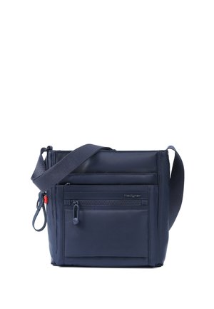Navy blue crossbody bag with adjustable wide strap, front zip pocket, and small red accent near the side zipper pull.