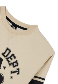 Felpa beige con collo a girocollo a coste, caratterizzata da testo grafico nero e strisce sulle maniche, realizzata in morbido cotone.