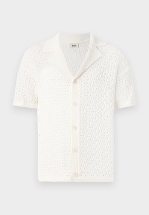 Short-sleeve, white knitted cardigan with a textured, open weave design and a classic collar. Features six button closures at the front.