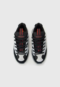 Black, white, and gray sneakers with red stripes and "globe mullen" logo on the tongue, viewed from above on a plain white background.