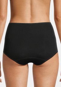 Hochgeschnittene schwarze Panty aus glattem Stoff. Verfügt über eine enganliegende Passform mit dezenten Steppnähten am Bund und an den Beinöffnungen.