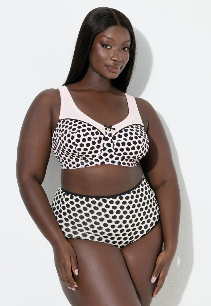 Pilkkukuosinen alusasusetti pehmeässä vaaleanpunaisessa ja mustassa. Settiin kuuluu rintaliivit leveillä olkaimilla ja pienellä rusettikoristeella sekä korkeavyötäröiset alaosat.