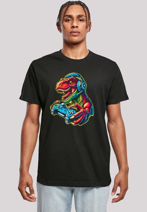 Black T-shirt featuring a colorful graphic of a dinosaur wearing headphones and holding a game controller. Short sleeves, standard fit.