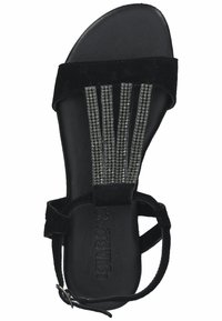 Black suede sandal with thin straps featuring metal studs, flat sole, and an adjustable buckle closure. Smooth interior texture.