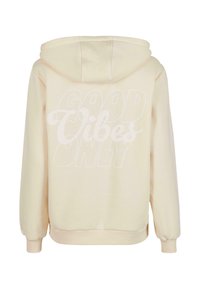Hoodie beige chiaro con grande testo stampato bianco "GOOD VIBES ONLY" sulla schiena. Ha un cappuccio con cordino e polsini elasticizzati.