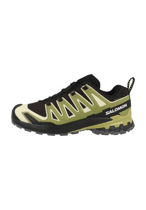 Salomon running shoe featuring a green and black design, mesh upper, textured surface, and rubber outsole with traction grooves.