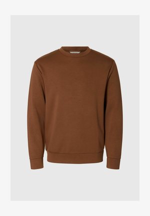 Ruda palaidinė su minkšta medžiaga, turi apvalų iškirpimą, ilgomis rankovėmis bei rausvais rankogaliais ir apačia, suteikiančiais prigludusį vaizdą.