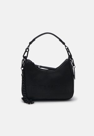 Black leather shoulder bag with short strap, chain detail, and embossed brand name on front, displayed on white background.
