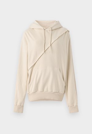 Sudadera beige hecha de una tela suave. Presenta un acento diagonal cosido, un bolsillo frontal y puños y dobladillo de canalé.