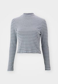 Juostuota ilgomis rankovėmis turtlenecko tipo palaidinė, pagaminta iš minkštos medžiagos. Yra siauri horizontalūs juodi ir balti dryžiai bei prigludusi forma.