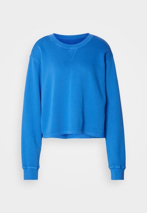 Sudadera azul cortada hecha de material suave, con mangas largas, un cuello redondo y puños acanalados. Diseño minimalista sin patrones.
