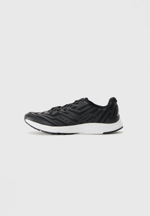 Black athletic sneaker with geometric patterns, lace-up design, and thick white sole, shown in left profile on white background.