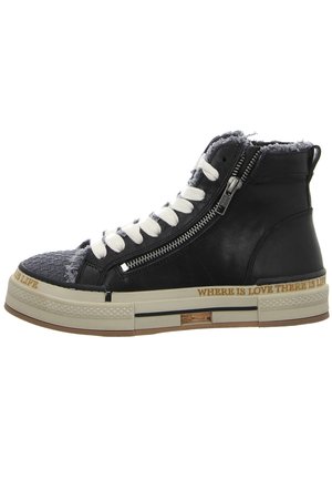 Black leather high-top sneakers with white laces, a textured gray toe cap, side zipper, and a tan rubber sole featuring printed text.