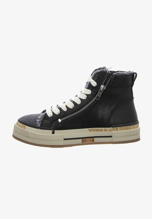 Black leather high-top sneakers with white laces, a textured gray toe cap, side zipper, and a tan rubber sole featuring printed text.