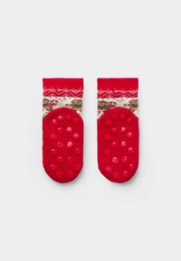 Red socks featuring a knitted design with gingerbread men and candy canes, textured rubber dots on the bottom for grip.