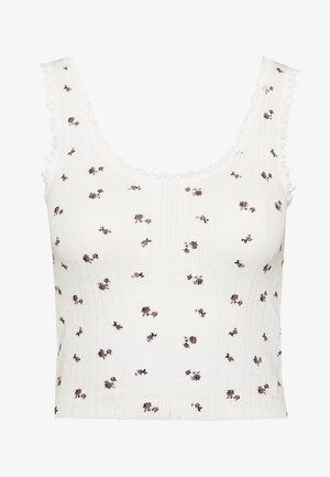 Witte tanktop met een gestructureerd patroon, met kleine bloemmotieven in roze en bruin. Golvende kantafwerking langs de halslijn en mouwen.