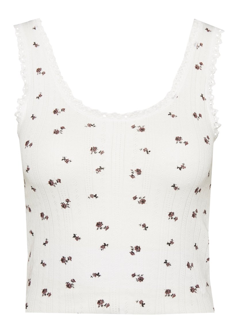 Top in cotone bianco con un motivo testurizzato, caratterizzato da piccoli motivi floreali in rosa e marrone. Bordo in pizzo smerlato lungo il colletto e le maniche.