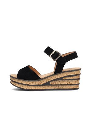 Black suede wedge sandals with an open toe, buckle strap, and a textured cork platform featuring a layered design and subtle curves.