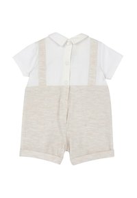 Combinaison à manches courtes avec un haut blanc et un short texturé beige. Dotée d'un col et d'une fermeture à boutons à l'arrière.