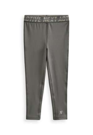 Grå aktiva leggings med en bred midja som har texten "ACTIVE NEXT ACT". Tillverkade av stretchigt material med platta sömmar och logodetaljer.