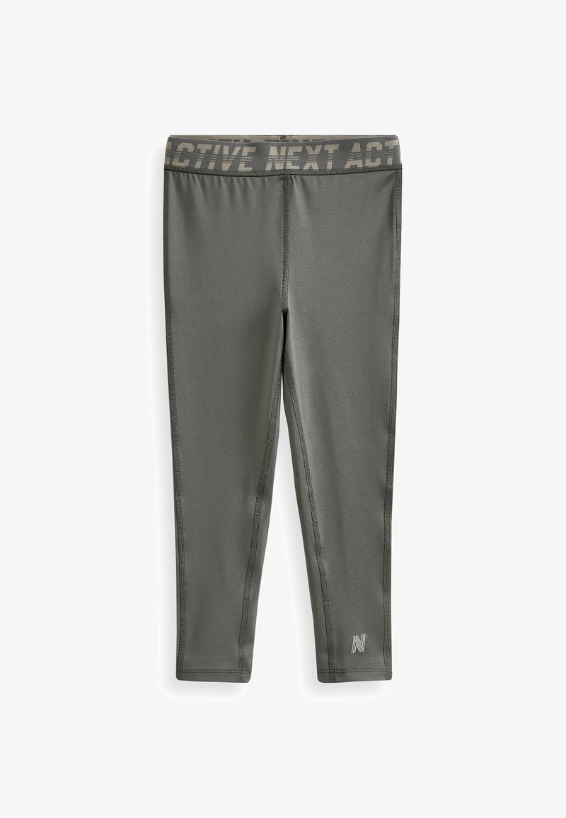 Leggings actifs gris avec une taille large portant le texte "ACTIVE NEXT ACT". Fabriqués en matériau extensible avec des coutures plates et un détail de logo.