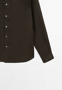 Dark brown long-sleeve button-up shirt with white buttons and a straight cuff on the right sleeve against a white background.