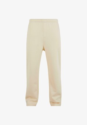 Beige Sweatpants mit elastischem Bund, zwei Seitentaschen und lockerer Passform. Hergestellt aus weichem Baumwollmaterial mit glatter Textur.