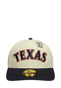 Cream cap with a dark blue brim. "TEXAS" is prominently embroidered in red and navy. Features a small black and white logo on the side.