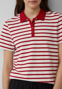 Rood en wit gestreept polo shirt met kraag en vijf drukknopen; korte mouwen; katoenen materiaal; casual pasvorm.