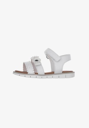 Sandalo bianco con design floreale, cinturini regolabili, suola testurizzata e accenti scallop. Presenta una soletta imbottita per il massimo comfort.