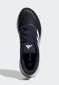 Navy athletic shoe with mesh upper, white three-stripe accent, lace closure, and cushioning midsole. Ortholite branding visible inside.