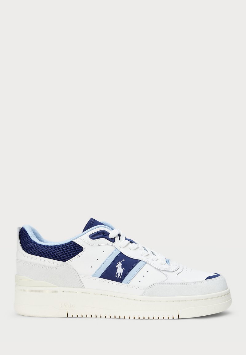 White athletic shoe featuring blue and navy accents, leather and mesh materials, perforated sides, and a textured rubber sole.